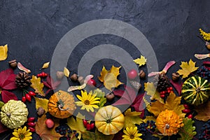 Autumn composition. Frame made of different multicolor dried leaves and pumpkin on dark background. Autumn, fall concept. Flat lay