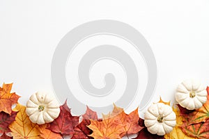 Autumn composition. Frame made of fallen leaves and pumpkins on white background. Flat lay, top view. Hygge style, autumn fall