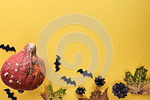 Autumn composition. Frame made of Pumpkins,dried leaves, pine cones and bats background. Template autumn, fall, halloween, harvest