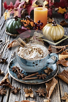 Autumn composition - Pumpkin spice latte, leaves and pumpkin on wooden background