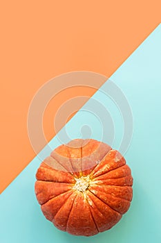 Autumn composition. Pumpkins on blue and orange background. Autumn, fall, halloween concept, Thanksgiving Day. Flat lay