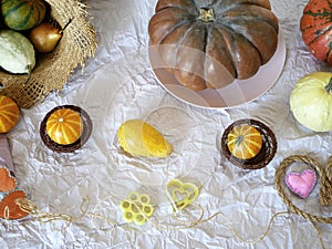 Autumn composition of pumpkins, hearts made of felt, straw hat, leaves