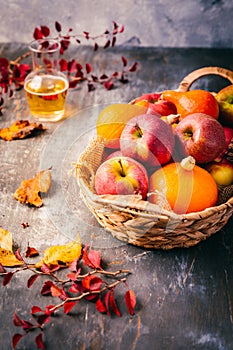 Autumn composition with pumpkins, autumn leaves, red apples and apple cider