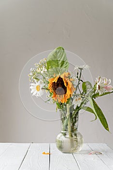 A bouquet of withered dry flowers in a vase on white