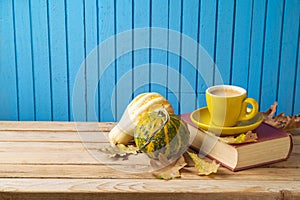 Autumn concept with coffee cup , pumpkin squash and fall leaves