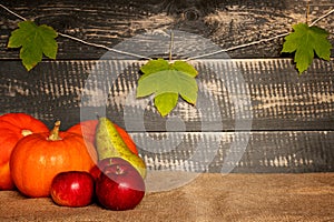 Pumpkins, apples and pear on jute bag . photo