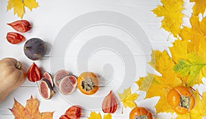 Autumn concept with seasonal fruits and vegetables. Pumpkin, figs, autumn leaves. Autumn background. Copy of the space