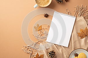 Autumn concept. Top view photo of notepad cup of coffee saucer with cookies anise yellow maple leaves plaid and pine cones on