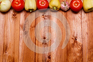 Autumn cooking background with seasonal organic vegetables on wooden table, top view, copy space