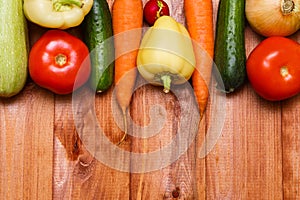 Autumn cooking background with seasonal organic vegetables on wooden table, top view, copy space