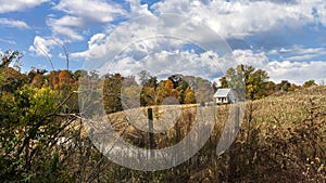Autumn country landscape with farmhouse