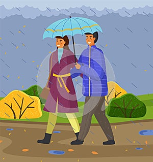 Autumn, couple of happy girl and guy with umbrella hugging walking in park under falling rain