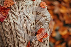 Autumn coziness: cable knit sweater and fall leaves