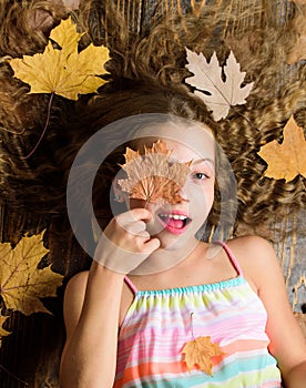 Autumn coziness is just around. Coziest things about fall. Kid cute girl relax wooden background autumn attributes top