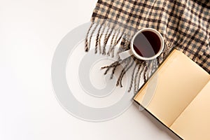 Autumn, cozy composition. Cup of tea, warm scarf, book, isolated on white background