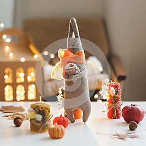 Autumn cozy still life with toy, candles and leaves. Cozy fall house decor, Thankgiving concept. Flat lay, hygge style