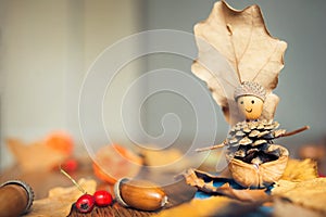 Autumn craft with kids. children`s cute boat with man made of natural materials