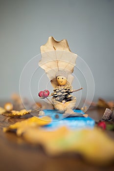 Autumn craft with kids. children`s cute boat with man made of natural materials