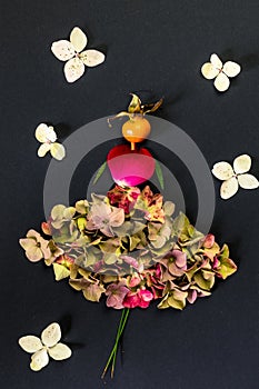 autumn creative ideas with colorful autumnal leaves and flowers, figure of woman