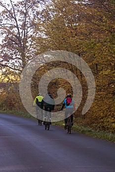 autumn cyclists on the autumn road