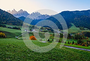 Autumn daybreak Santa Magdalena famous Italy Dolomites village view in front of the Geisler or Odle Dolomites mountain rocks.