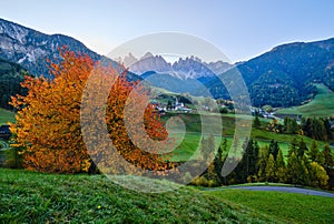 Autumn daybreak Santa Magdalena famous Italy Dolomites village view in front of the Geisler or Odle Dolomites mountain rocks.