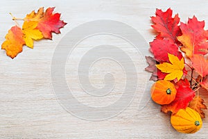 Autumn decor from pumpkins and leaves on a wooden background.