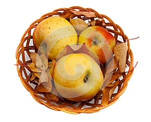 Autumn decoration with apples and leaves in a basket