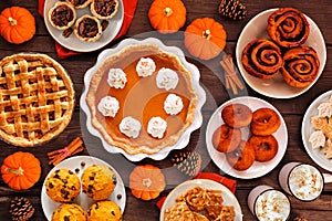 Autumn desserts table scene with an assortment of traditional fall treats, above view on a wood background