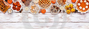 Autumn desserts top border with a collection of traditional fall sweet treats over a white wood banner background