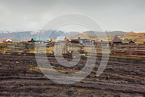 Autumn dirt road, impassable mud through the village. Wet rural road washed out by rains. Altai region