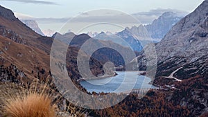 Autumn Dolomites mountain and Fedaia Lake, Italy.