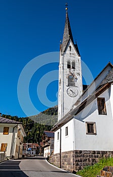 Autumn Dolomites village and old church, Falcade Alto, Italy photo