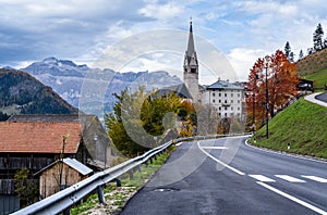 Autumn Dolomites village and old church, Livinallongo del Col di Lana, Italy photo