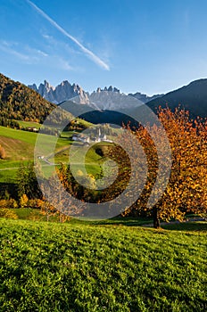 Autumn evening Santa Magdalena famous Italy Dolomites village view in front of the Geisler or Odle Dolomites mountain rocks.