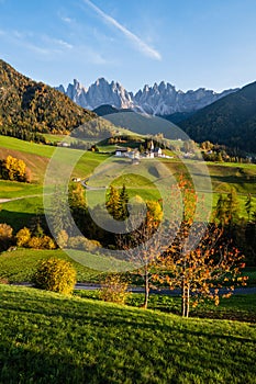 Autumn evening Santa Magdalena famous Italy Dolomites village view in front of the Geisler or Odle Dolomites mountain rocks.