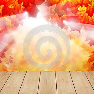 Autumn fall background with red leaves, sunlight and wooden planks