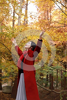 Autumn / fall beautiful woman happy in free freedom pose in autumn park