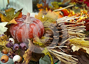 Autumn, fall decoration with a pumpkin, gourd, pine cone, berries, leaves