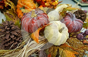 Autumn, fall decoration with a pumpkin, gourds, pine cone, leaves. Natural background.