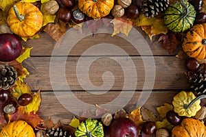 Autumn or fall flat lay composition frame, with copy space on wooden background.