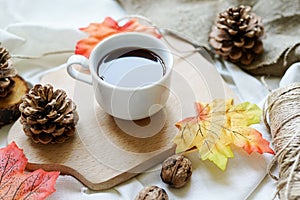 Autumn fall leaves, hot steaming cup of coffee on white background. relaxing and still life concept