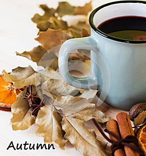 Autumn, fall leaves, hot steaming cup of glint wine