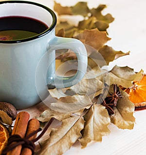 Autumn, fall leaves, hot steaming cup of glint wine