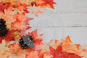 Autumn and Fall season background. Fake maple leaf on wood table. Harvest cornucopia and Thanksgiving day