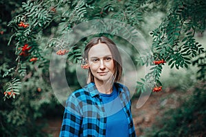 Autumn fall summer woman portrait. Closeup portrait of beautiful Caucasian middle age woman in park looking in camera. Pensive