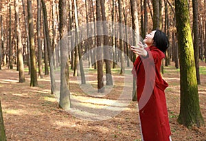 Autumn / fall beautiful woman happy in free freedom pose in autumn park Embrace nature