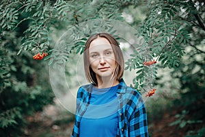 Autumn fall woman portrait. Closeup portrait of beautiful Caucasian middle age woman in park looking in camera. Pensive woman in a