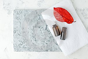 Autumn falll Seasonal Spa set Massage essential oils, towels on gray marble plate, organic cosmetic products, aromatherapy and photo