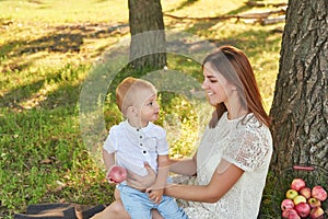 Autumn family walk in forest. Happy mother and baby boy. Family with little son in autumn park. Family and mother`s day. Children